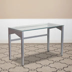 Bureau contemporain en verre trempé transparent avec pieds géométriques et cadre argenté